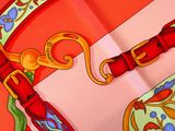 a picture of a red and yellow scarf with a red buckle