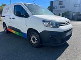 the van is parked on the side of the road in front of a building