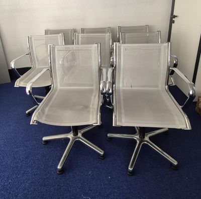 several chairs are lined up in a row on a blue carpet
