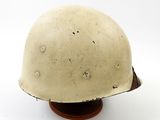 an old helmet on a wooden base on a white background
