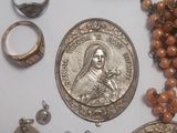 a lot of silver and gold jewelry on a table