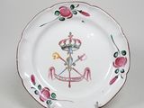 une image représentant une assiette blanche ornée d'un motif rose et vert