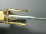 a close up of a small metal object with a needle sticking out of it