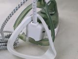 a green and white device that is connected to a white cord