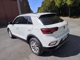 the rear end of a white volkswagen suv parked in a parking lot