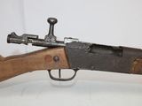 a close up of a rifle on a table with a white background
