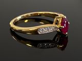 an image of a diamond and ruby ring on a black surface