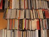 a lot of dvds stacked on top of each other on the floor
