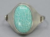 silver ring with a turquoise stone in the middle of it