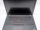 the laptop is open on a white surface with a black keyboard
