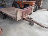a tractor with a trailer attached to it in a garage