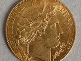 a close up of a gold coin with a woman ' s head on it