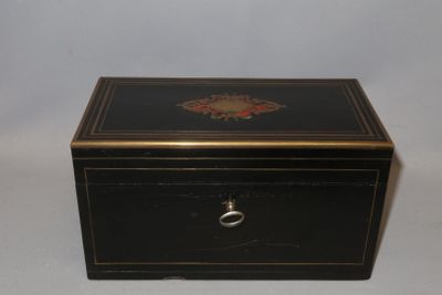 an image of a black and gold box with a flower design on it