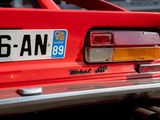 a close up of a red car with a license plate on it