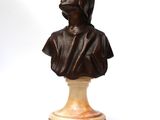 an antique bronze bust of a woman on a marble base