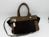 brown and black handbag sitting on top of a white table next to a soccer ball