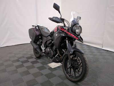 a motorcycle that is parked in a room with a checkered floor