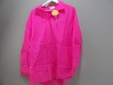 bright pink shirt hanging on a hanger against a gray wall