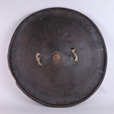 a large metal plate with holes in the middle of it