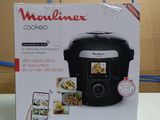 packaging of a black rice cooker sitting on top of a counter