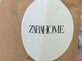 a brown paper bag with a sticker that says zarhome