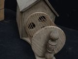 a small bird cage with a bird inside of it