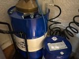 a blue drum with a brass top and a blue drum with a white stripe