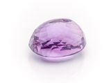 a close up of a purple gemstone on a white surface