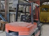 a forklift truck parked in a warehouse with other equipment