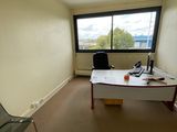 a room with a desk and a chair in it