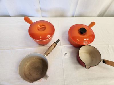 three pots and pans sitting on a table