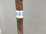 a close up of an old axe with a sticker on it