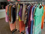 a lot of clothes hanging on a rack in a store