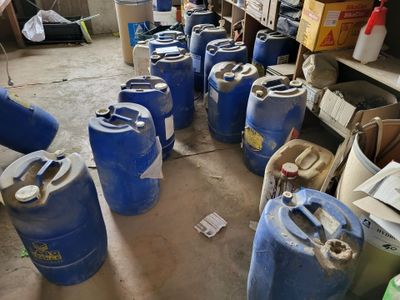 many blue barrels lined up in a room