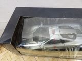 a model of a car in a box on the floor