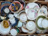 a box full of different types of tea cups and saucers
