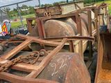 many rusted tanks sitting on the side of the road