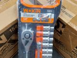 two boxes of wrenches and a pair of wrenches on the floor