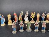 many figurines of different sizes and colors on the table