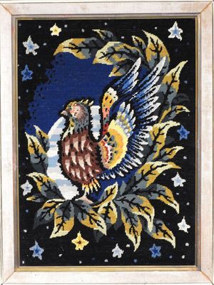 une image représentant une broderie au point de croix représentant un oiseau perché sur une branche