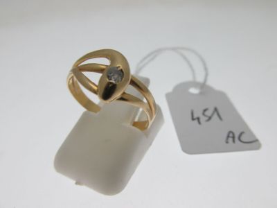 a gold ring with a diamond on it next to a price tag