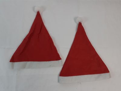 pair of red santa hats with white trims on a white background