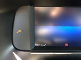 a close up of a cell phone on a car ' s dashboard