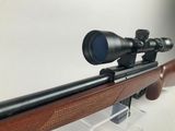 a close up of a rifle with a scope mounted on it