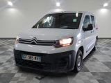 the white van is parked in a large room with a checkered floor