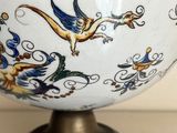a white bowl with blue and yellow designs on it