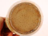 a person holding a cup of coffee in their hand