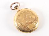 a gold pocket watch with a picture of a woman on it