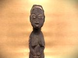 a statue of a woman sitting on a table