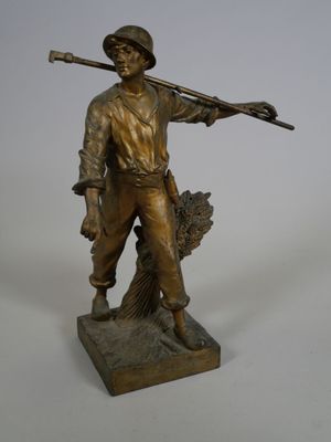 statue of a man holding a rifle and a bird on a base